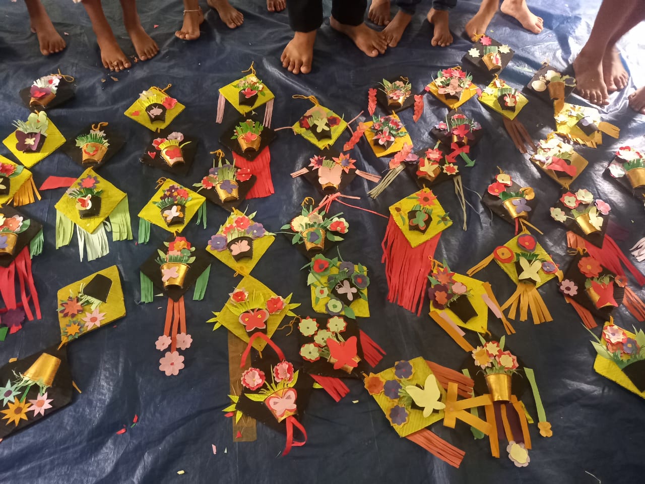 Handmade paper kites with flower baskets made by students